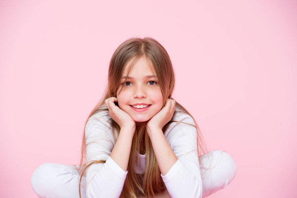 Beauty look and hair care, punchy pastel. Little girl smile pink background. Happy child with cute face. Beauty kid with fresh look and long blond hair. Childhood and childcare. - Photo, image