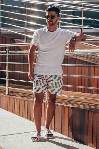 Portrait of young stylish man near the pool deck on sunny summer day. Lifestyle. - Fotografie, Obrázek