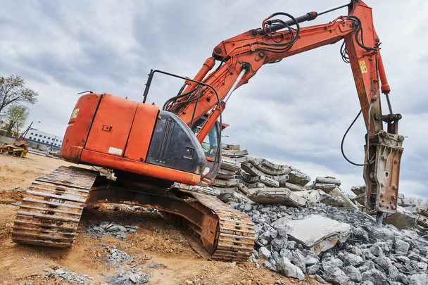 excavator loader machine at demolition with hydrohammer on construction site - Fotó, kép