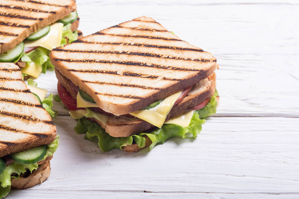 Club sandwich with tomatoes , cucumber , ham , cheese and salad . Clubsandwich - Photo, image