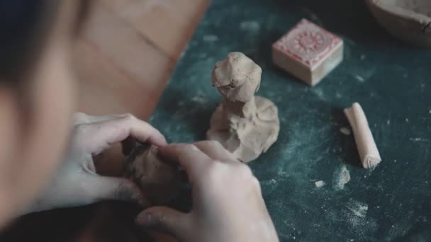 child sculpts the clay craft. the little girl is engaged in pottery - Footage, Video