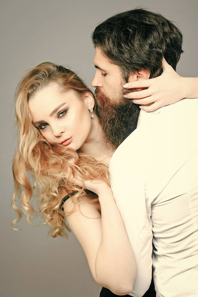 Passionate couple kissing, boy and girl. Couple in love with trendy hairstyle hug on grey background - Φωτογραφία, εικόνα