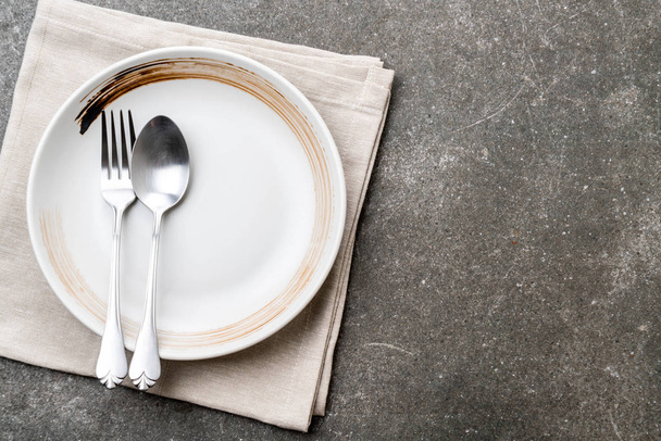 empty plate spoon fork and knife on table - Fotó, kép