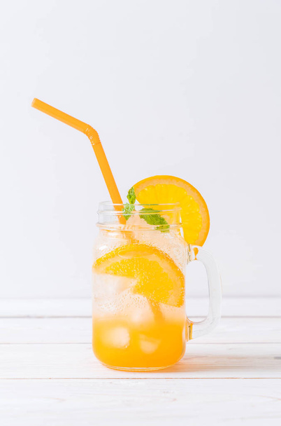 orange juice with soda on wood table - Valokuva, kuva