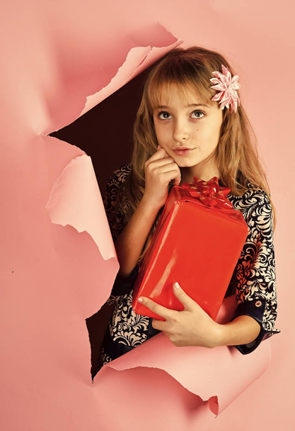 Child Childhood Children Happiness Concept. Small girl with shopping package, black friday. Birthday and christmas. Childhood and happiness, gift box. Child girl with present pack, cyber monday - 写真・画像