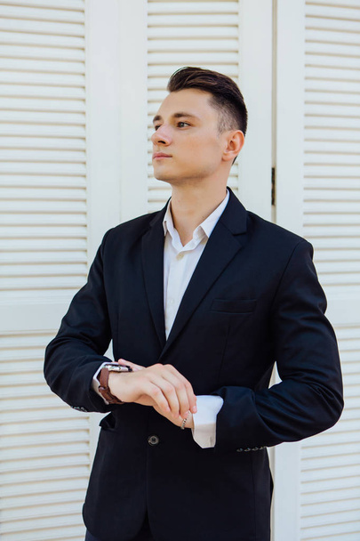 Portrait of handsome man in black suit on the white background - Fotografie, Obrázek