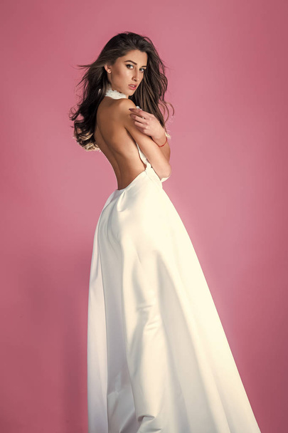 Sensual woman body. Beautiful fashion woman brunette hair makeup wear silk white long dress for party date sexy woman pretty face perfect body birthday girl bridesmaid bride wife wedding day clothes - Fotó, kép