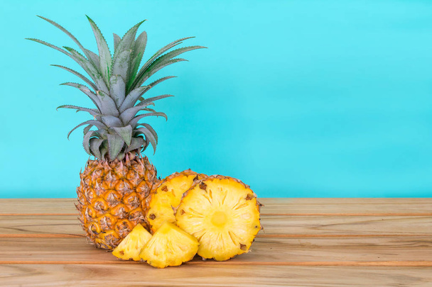 the pineapple fruit on wooden table with white background , summer fruit drink concept - Photo, Image