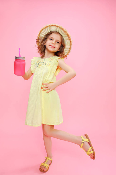 Playful girl in summer outfit with drink - Valokuva, kuva