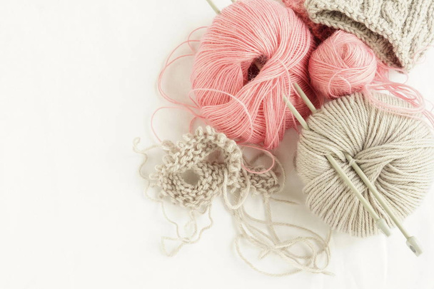 Grey and pink  knitting wool and knitting needles on white background. top view.copy space.Close up - Foto, immagini