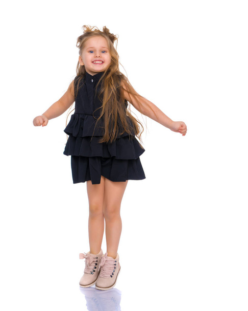 A cheerful little girl is dancing. - Fotografie, Obrázek