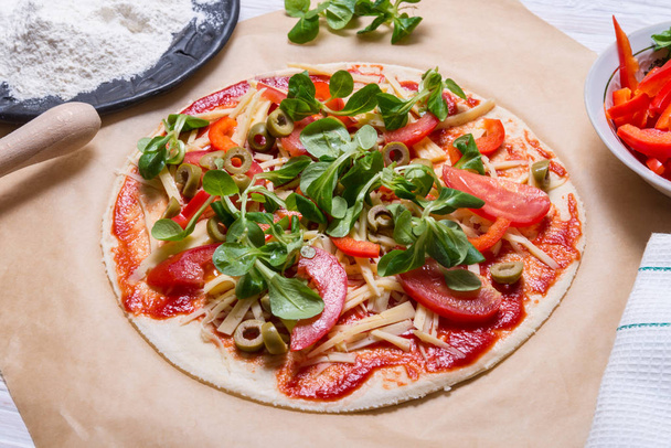 Raw pizza on kitcken table - Fotó, kép