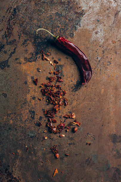 top view of chilli flakes and chili pepper on grungy table - Photo, Image