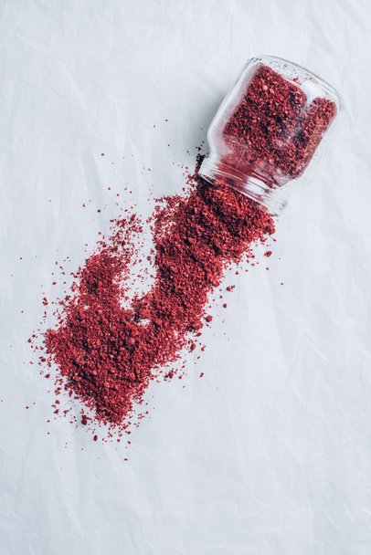 top view of scattered powdered chili pepper on white table - Photo, Image