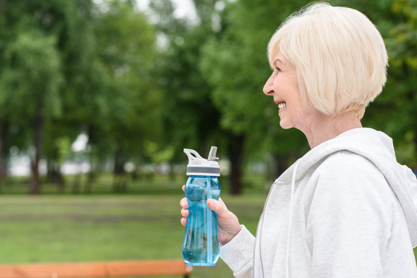 profilo ritratto di felice donna anziana in possesso di bottiglia sportiva
 - Foto, immagini