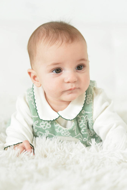 Cute  baby girl  on white  blanket  - Fotó, kép