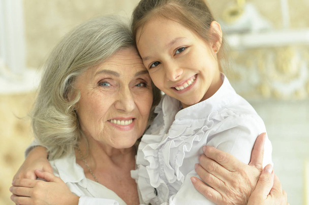 portrait of  grandmother and granddaughter at home - Fotó, kép