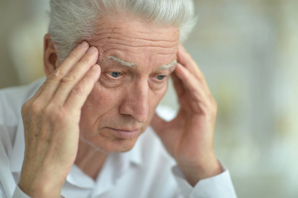 Senior man with headache at home - Φωτογραφία, εικόνα