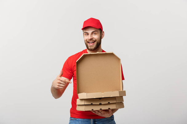 Pizza delivery concept. Young boy is delivering and showing pizza boxs in boxes. Isolated on white background - Valokuva, kuva