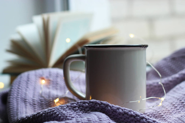 a garland, a cup, a plaid and a book on the windowsill. minimalism, top, insta - Photo, Image