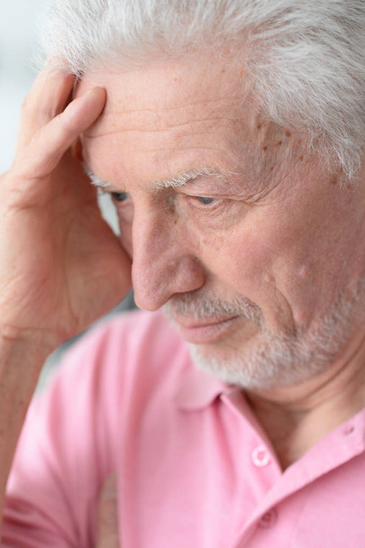 Senior man with headache at home - Fotoğraf, Görsel