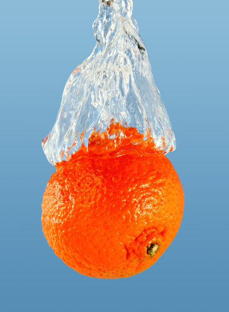 orange in a jet of water. - Photo, Image