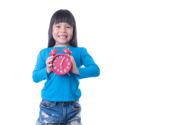Little girl is holding small alarm clock, isolated over white - Φωτογραφία, εικόνα