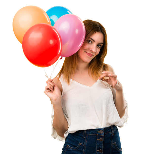 Beautiful young girl holding a balloon and proud of herself - Photo, Image
