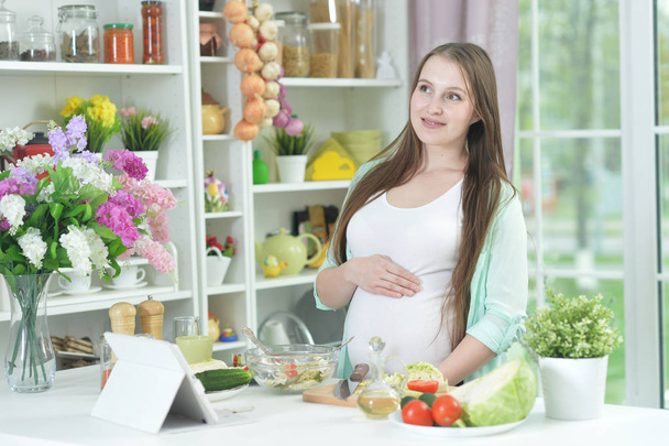 beautiful pregnant woman at kitchen - 写真・画像