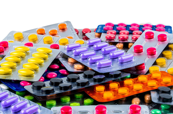 Куча таблеток изолированы на белом фоне. Yellow, purple, black, orange, pink, green tablet pills in blister pack. Обезболивающее. Лекарство от мигрени. Фармацевтика
. - Фото, изображение