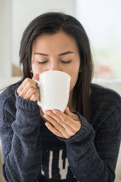 Portrait of happy brunette with mug in hands - Фото, изображение