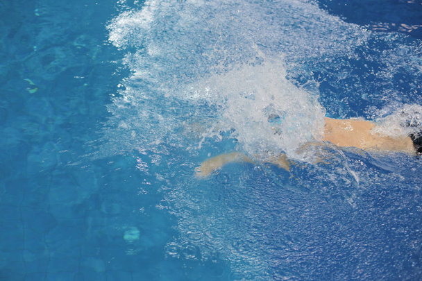 Male swimmer at the swimming pool. Underwater photo. Male swimmer. - 写真・画像