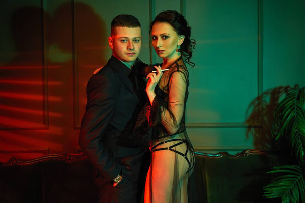 Young gorgeous fashion couple posing - 写真・画像