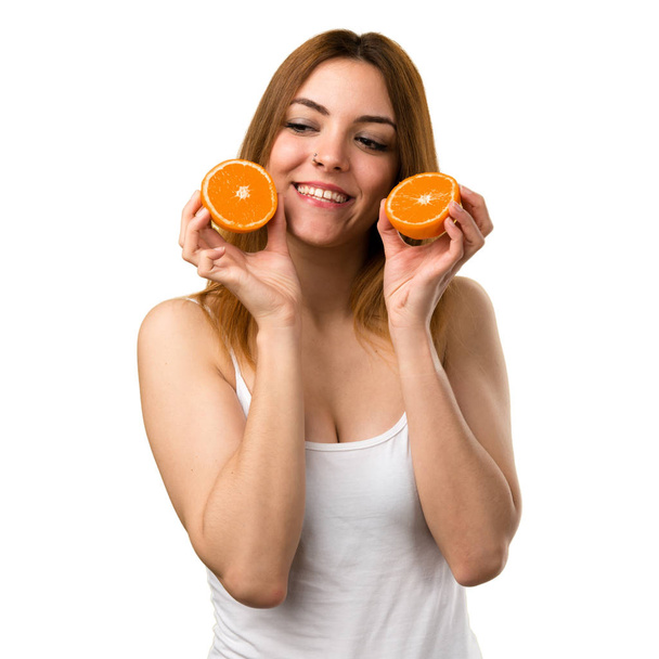 Beautiful young girl holding an orange juice - Fotoğraf, Görsel