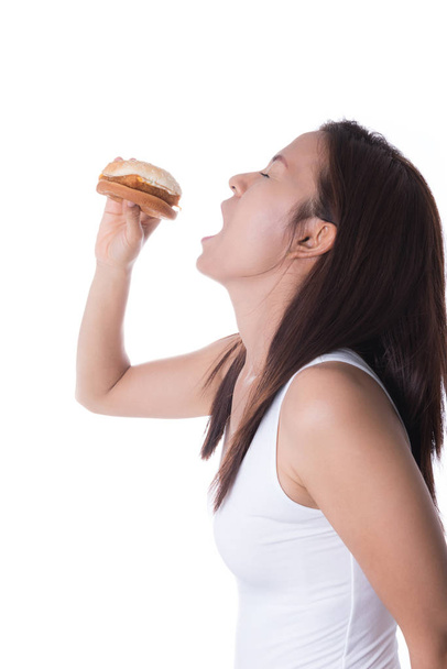 woman biting hamburger on white background - 写真・画像