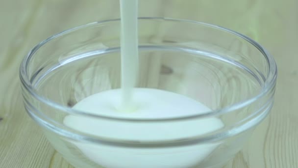 man fill the transparent cup with white yogurt, ready for insert healthy strawberries, concept of healthy fruit food nutrition - Video, Çekim