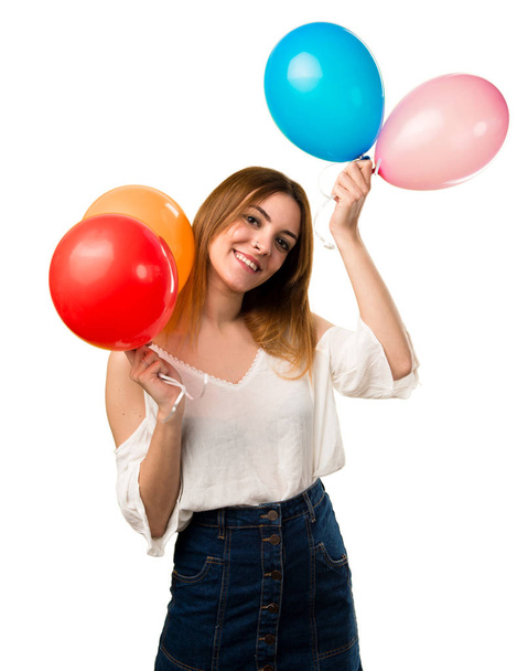 Happy beautiful young girl holding a balloon - Фото, изображение
