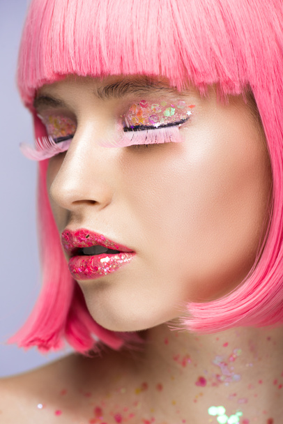 beautiful girl with pink hair and glittering makeup on violet - Photo, image