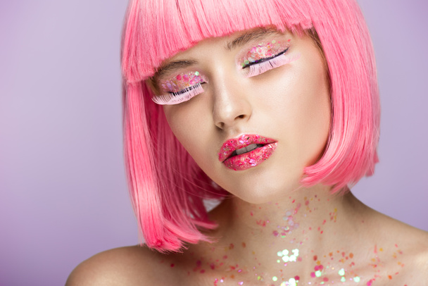 attractive woman with pink hair, glittering makeup and long eyelashes isolated on violet - Photo, Image
