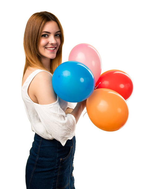 Happy beautiful young girl holding a balloon - 写真・画像