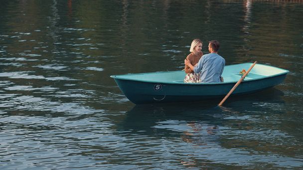 Attractive young couple in a boat outdoors - Photo, Image