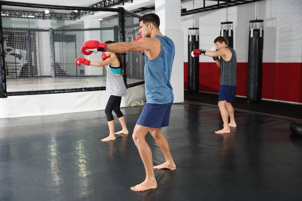 Young boxers warming up before training in gym - Photo, image