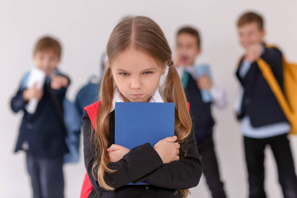 Children bullying their classmate on light background - Photo, image