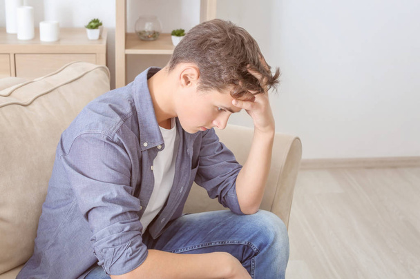 Depressed teenager on sofa - Foto, afbeelding