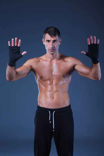 portrait of hand wrapping half nude boxer. Personal fitness instructor. Personal training. - Fotó, kép