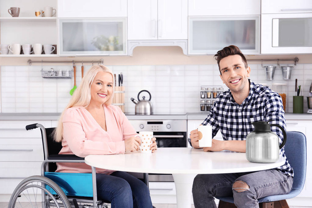 man and mature woman in wheelchair  - Photo, Image