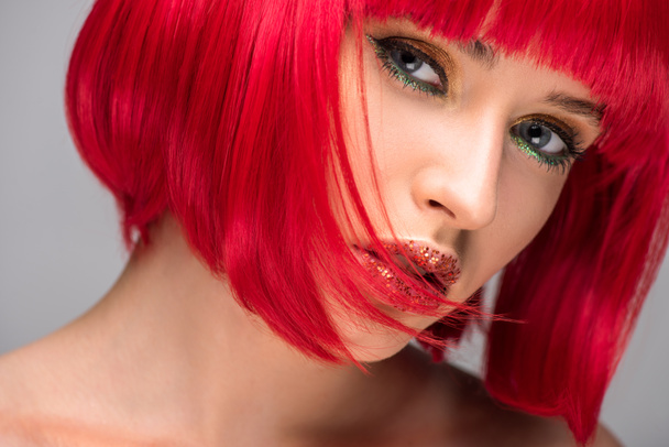 headshot of beautiful woman with red hair and glitter on face looking at camera - Fotó, kép