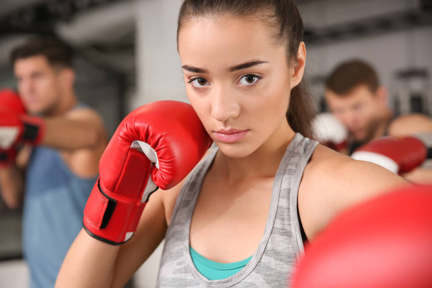 Portrait of young female boxer in gym - Φωτογραφία, εικόνα