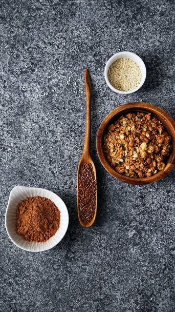 healthy sweets cooking ingredients in separate bowls on gray background  - Fotó, kép