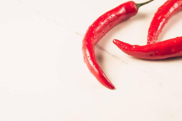 fresh red chili pepper/fresh red chili pepper on a white marble  background. Sective focus. Copy space - Φωτογραφία, εικόνα